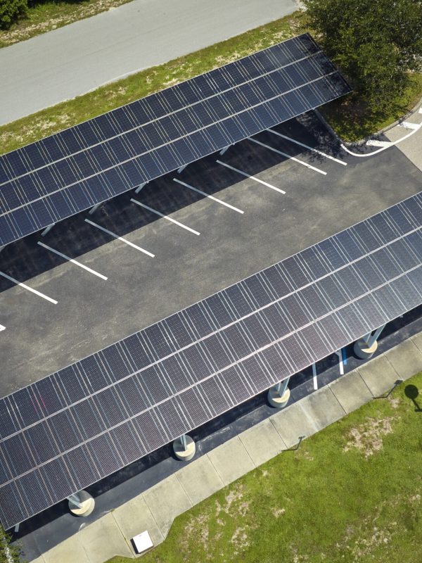 Solar panels installed over parking lot for parked cars for effective generation of clean energy.
