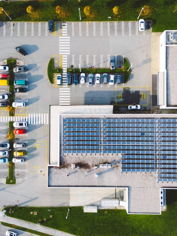 Aerial view of discount retailer chain with a large parking lot somewhere in the countryside of Slovenia.